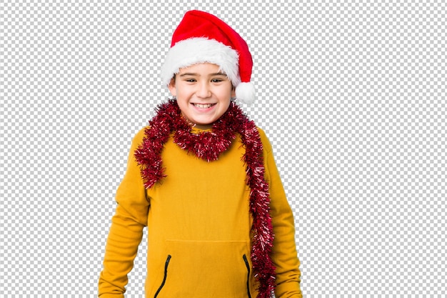Мальчик празднуя рождество нося шляпу santa изолировал счастливый, усмехаться и жизнерадостный.