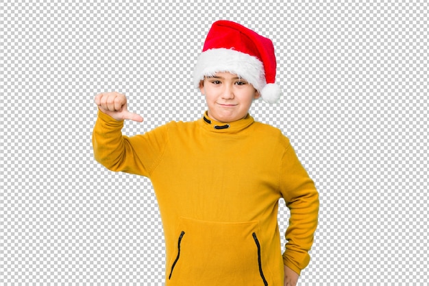 PSD 親指を下げて、嫌いなジェスチャーを示すサンタ帽子をかぶってクリスマスの日を祝う少年。不一致の概念。