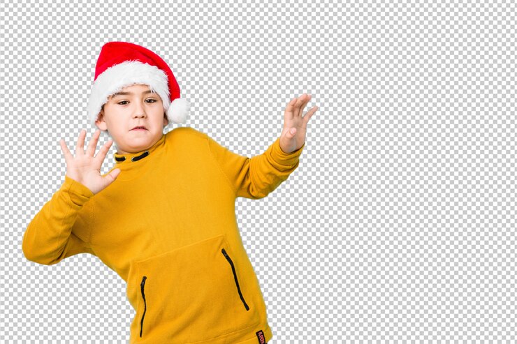 PSD little boy celebrating christmas day wearing a santa hat being shocked due to an imminent danger