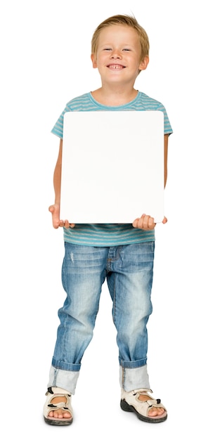 little boy holding blank paper board studio portrait