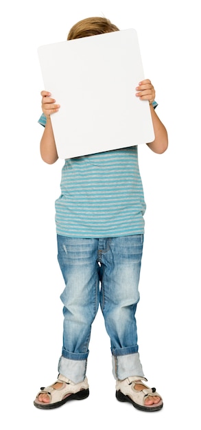 PSD little boy holding blank paper board studio portrait