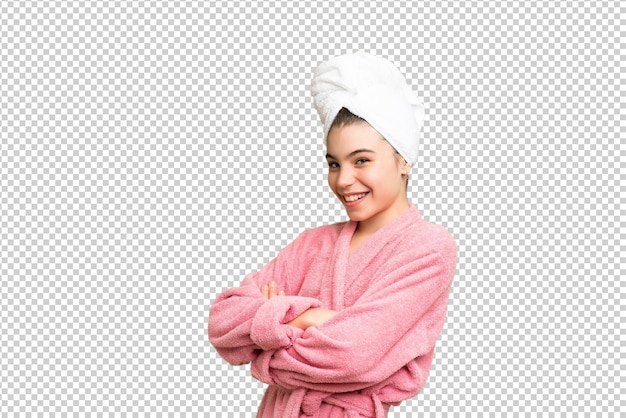 Little girl in a bathrobe over isolated chroma key background with arms crossed and looking forward