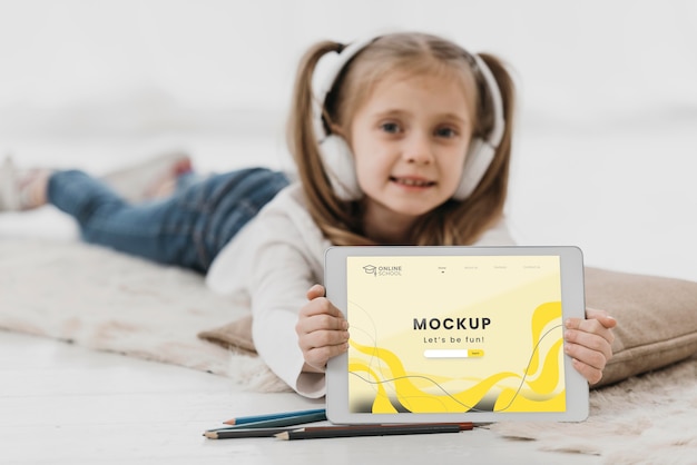 little girl in bed with tablet