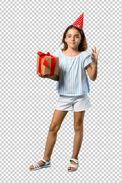 PSD little girl at a birthday party holding a gift showing an ok sign with fingers