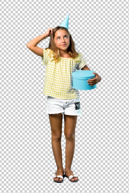 Little girl at a birthday party holding a gift standing and thinking an idea