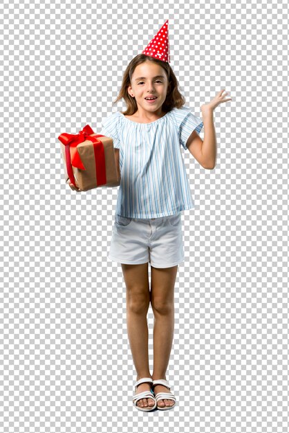 Little girl at a birthday party holding a gift with surprise and shocked facial expression