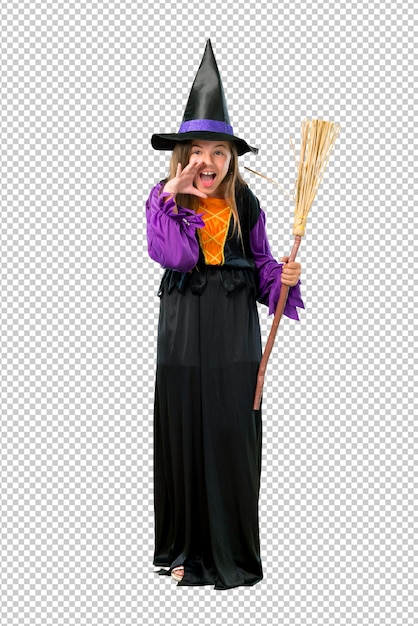Little girl dressed as a witch for halloween holidays shouting with mouth wide open