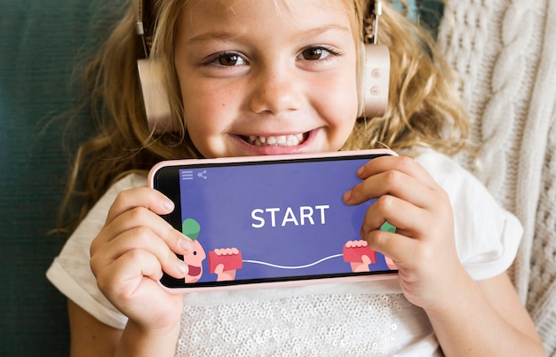 PSD little girl playing a mobile game