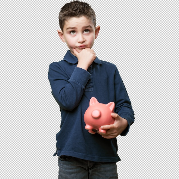 little kid thinking with piggy bank