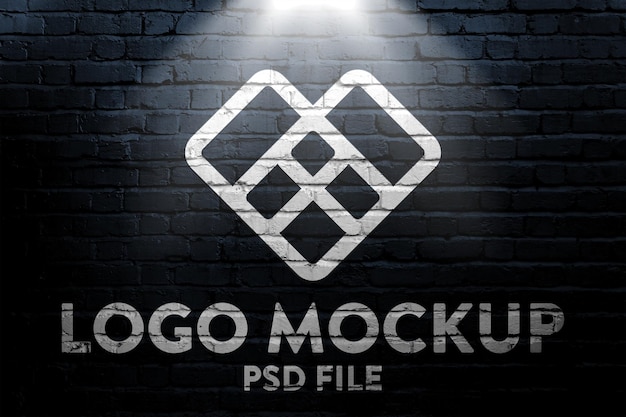 Logo mockup on a dark brick wall with light