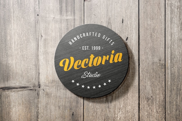 Logo mockup of metal sign on wooden wall