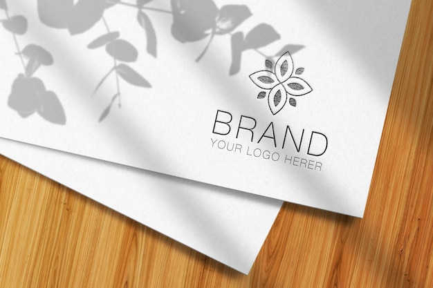 PSD logo mockup presentation on paper and wooden bacckground