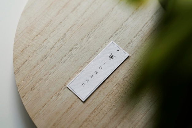 Logo mockup tag on wooden with plant