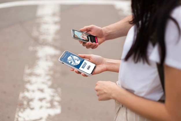 PSD lovely couple holding phones mock-up