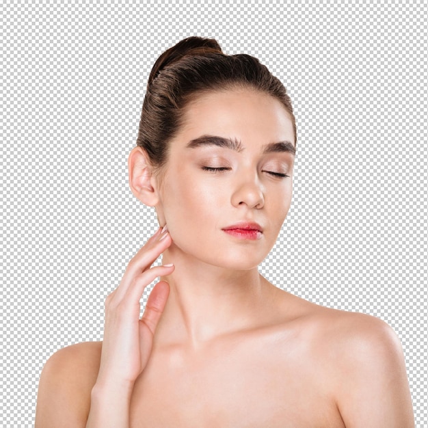 Lovely female model with brown hair in bun taking pleasure with closed eyes while doing skin care treatment