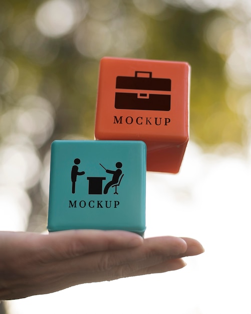 Low angle of hand holding business cubes