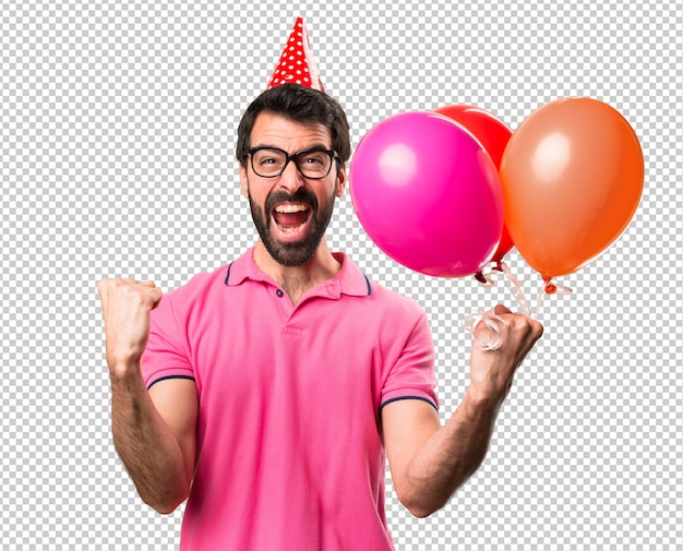 Lucky handsome young man holding balloons