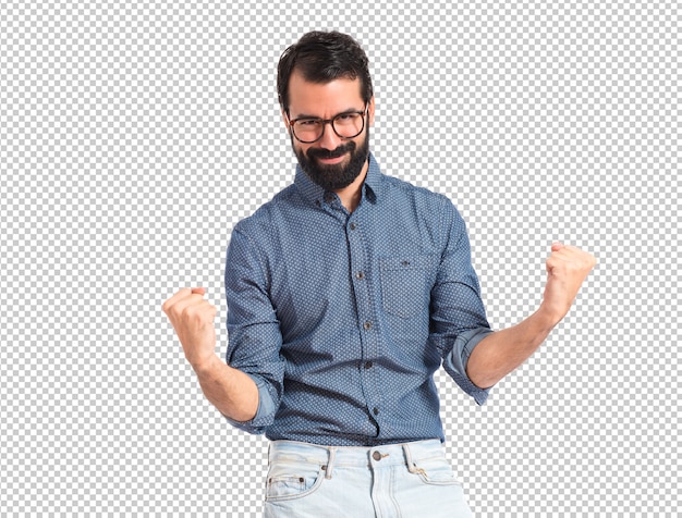 Lucky young hipster man over white background