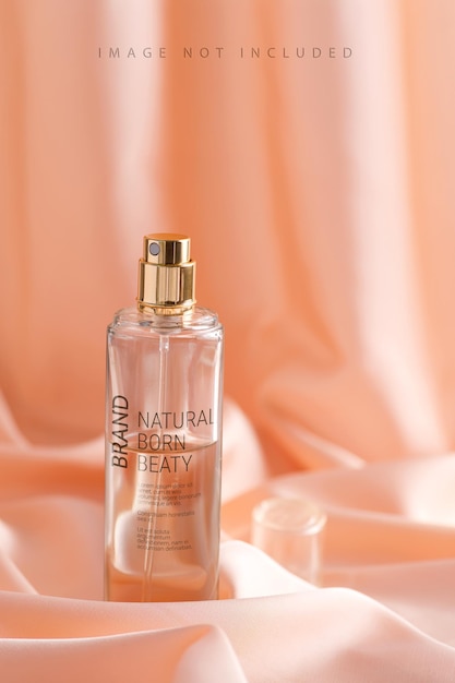Luxurious perfume bottle on a draped silk fabric in beige tones