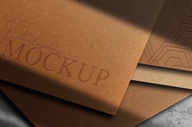 Luxury brown paper close up embossed logo mockup card stack top view