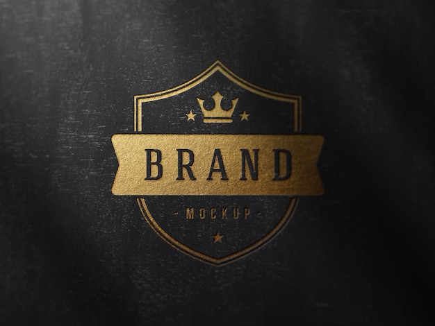 Luxury debossed gold foil logo mockup on textured black wood