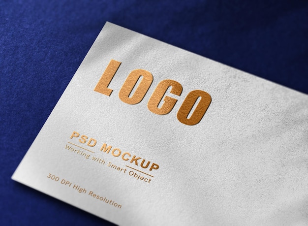 Роскошный макет золотого логотипа с тиснением на белой бумаге