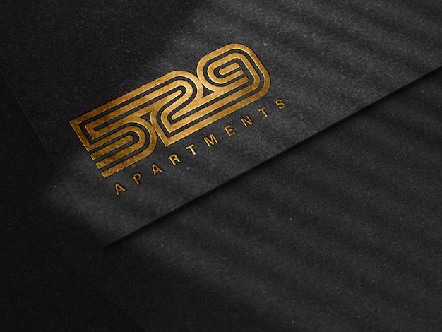 PSD luxury embossed logo mockup on black paper texture