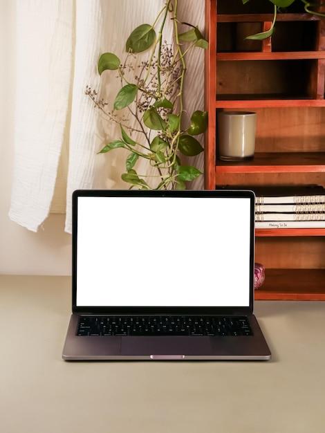 PSD macbook wallpaper mockup on work desk with wood shelf template photo