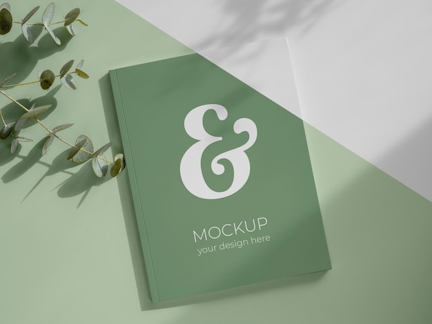 PSD magazine and leaves mockup flat lay