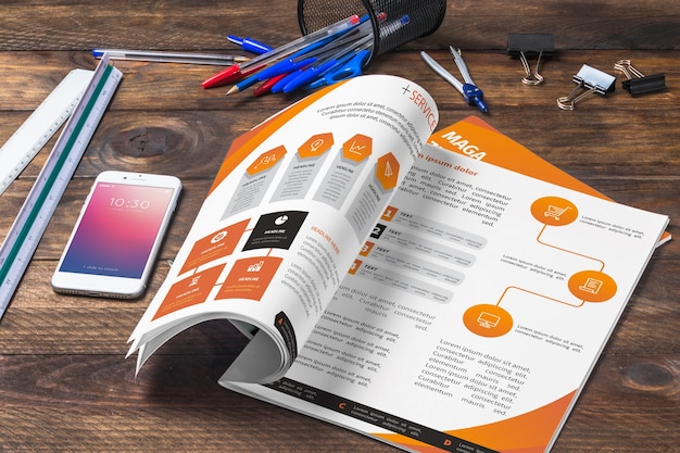 Magazine and smartphone mockup on wooden table with pens and rulers 