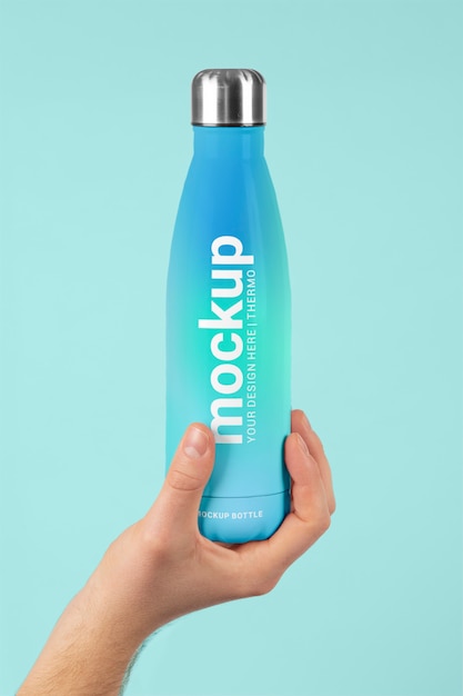 Male hand holding mock-up of blue thermos bottle