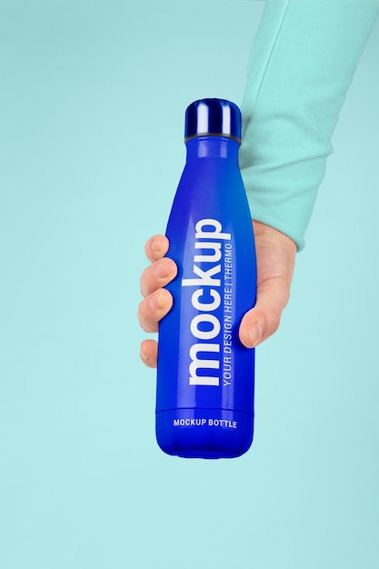 Male hand holding mock-up of blue thermos bottle