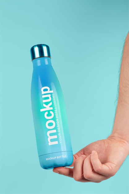 PSD male hand holding mock-up of blue thermos bottle