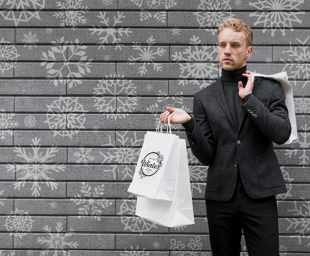 PSD male holding shopping bags copy-space