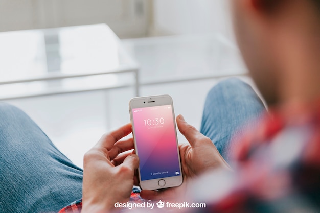 PSD man on couch looking at smartphone