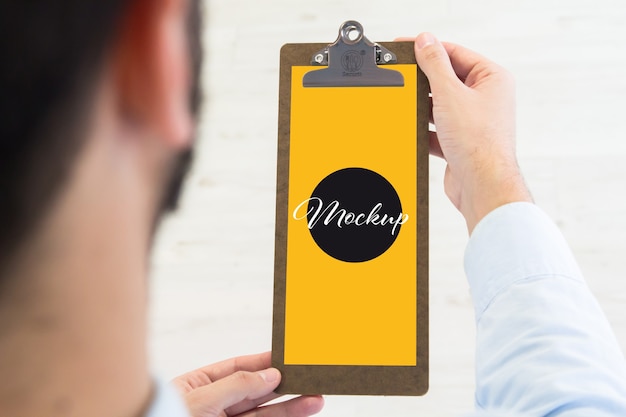 Man holding a clipboard mockup