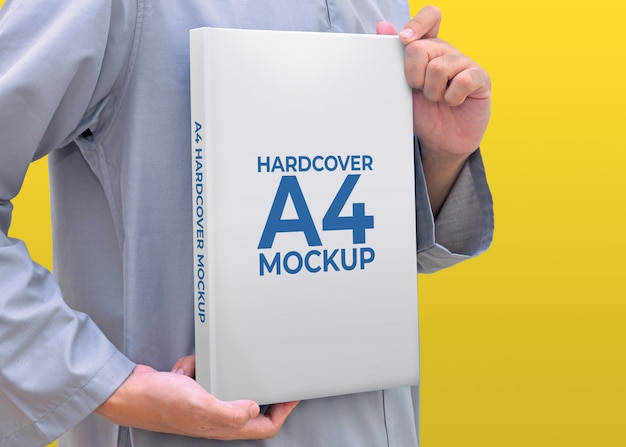 Man Holding Hardcover Book A4 Size With Colour Background Mockup