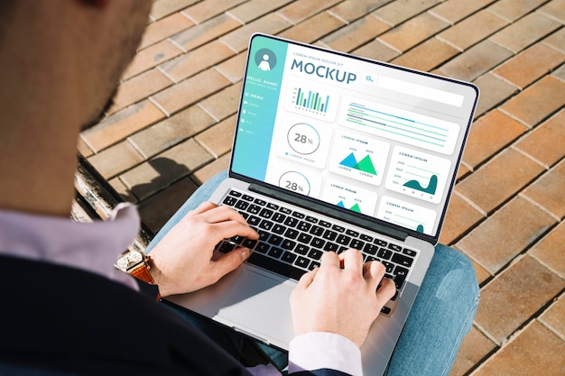 Man holding a mock-up laptop for work