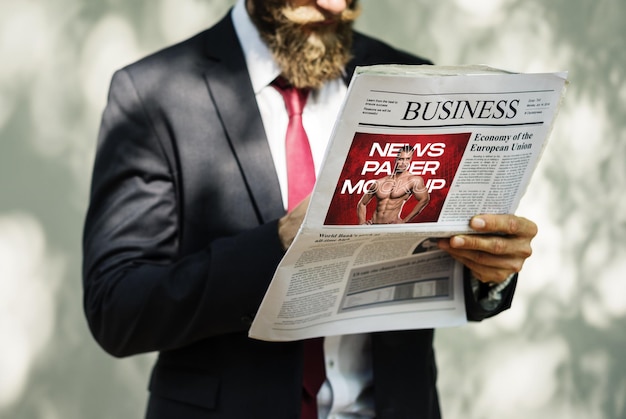 a man holding a newspaper with a newspaper in his hand