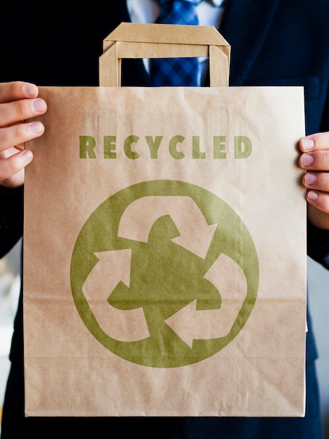 PSD man holding a paper bag mock-up