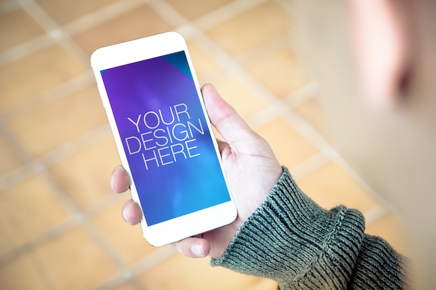 PSD man holding smartphone mockup