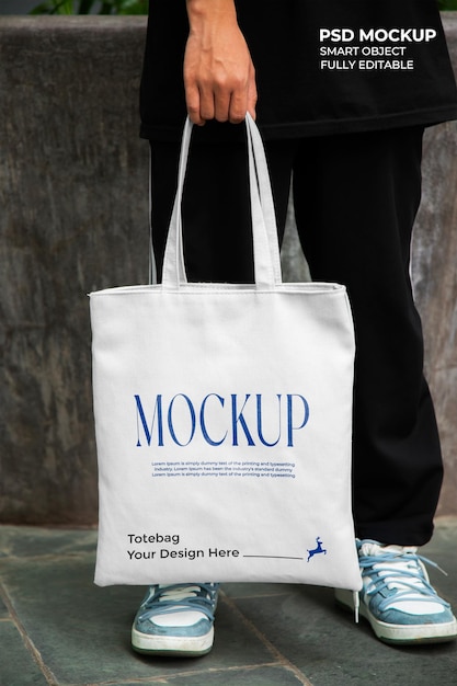 man holding tote bag mockup front view