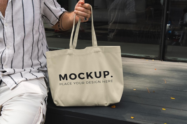 Man holding a tote bag mockup