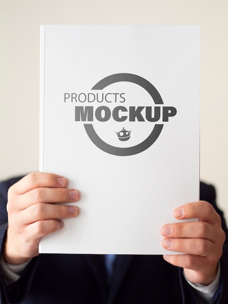 Man holding up a notebook mock-up