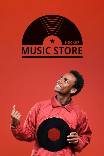 PSD man holding vinyl disk for music store mock-up