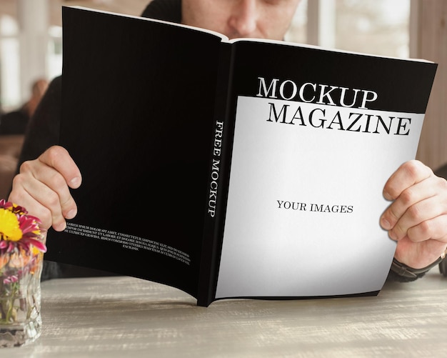 A man is reading a magazine mockup psd that says your images