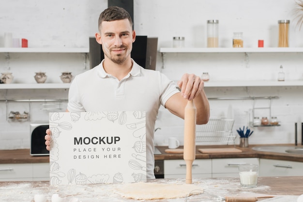 Man in the kitchen holding rolling pin