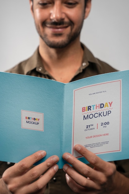 PSD man looking at invitation mockup