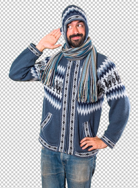 PSD man met winterkleren luisteren iets