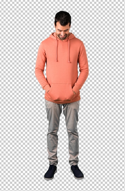 Man in a pink sweatshirt standing and looking down
